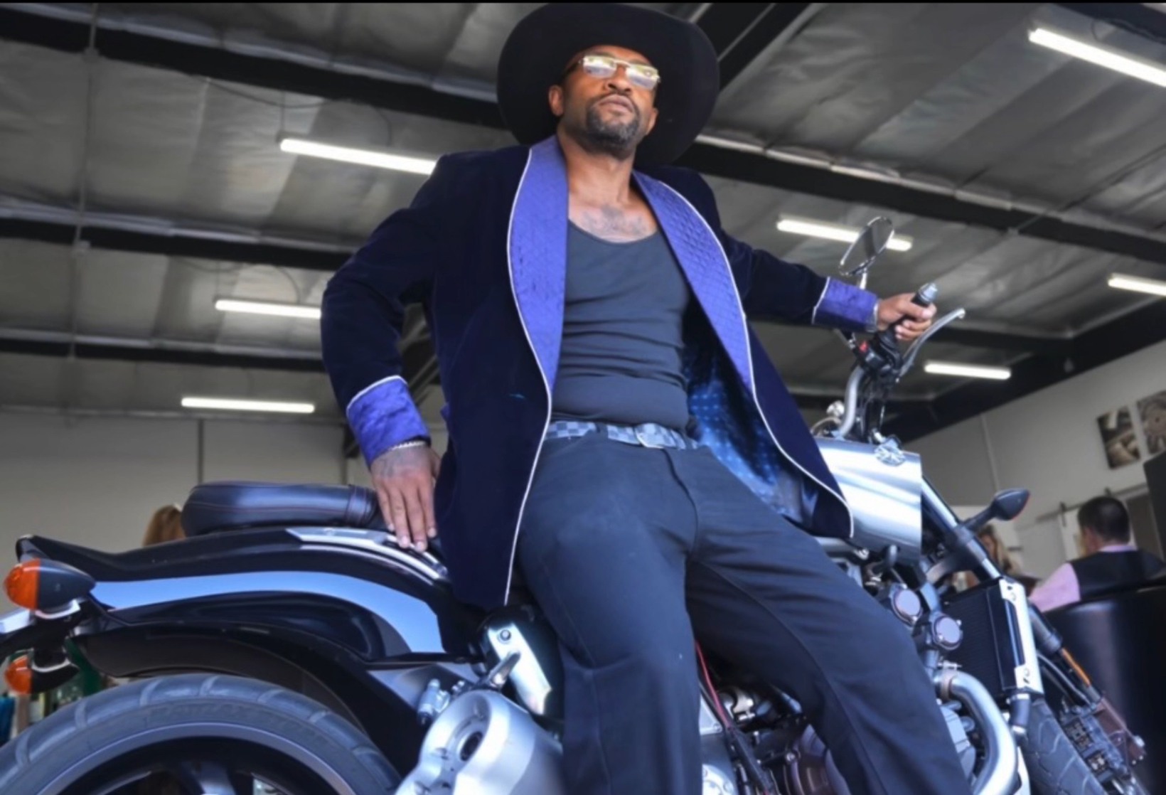 Country J in velvet blazer on motorcycle